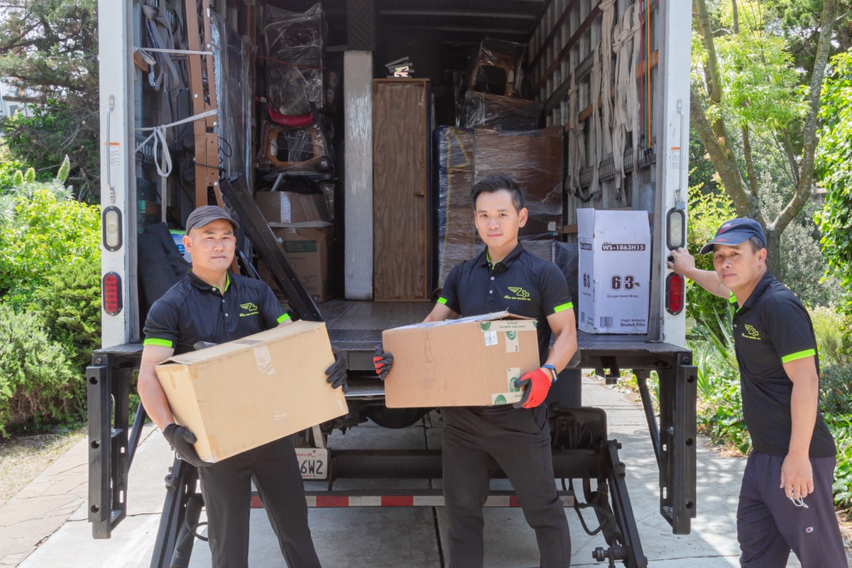 Movers unloading boxes from the truck